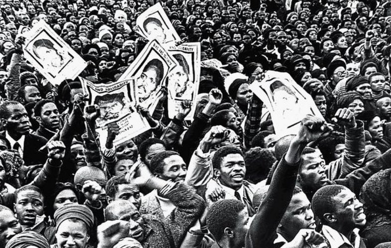 Demonstrators hold up images of Steve Biko at his funeral in September 1977 after he had been murdered in police custody.