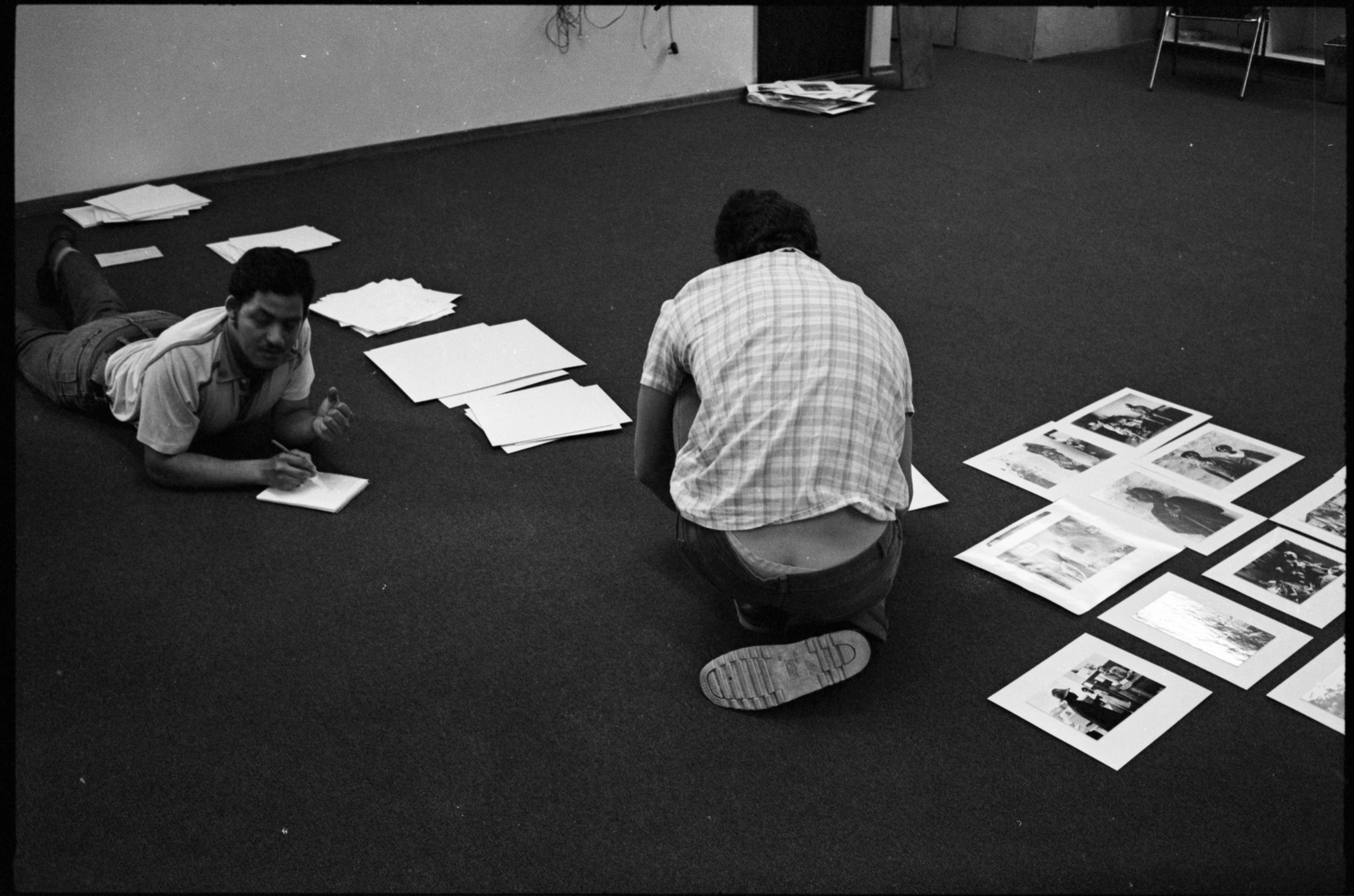 Paul Weinberg and Chris Van Wyk selecting images for the first Staffrider exhibition 1983