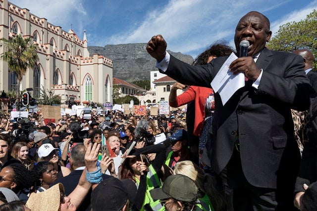 President Cyril Ramaphosa appears before protesters against gender- based violence in South Africa