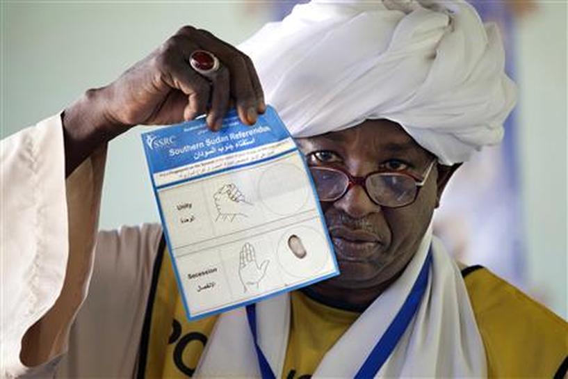 A Southern Sudan Referendum Commission staff member shows the voting ballot during the official counting of votes