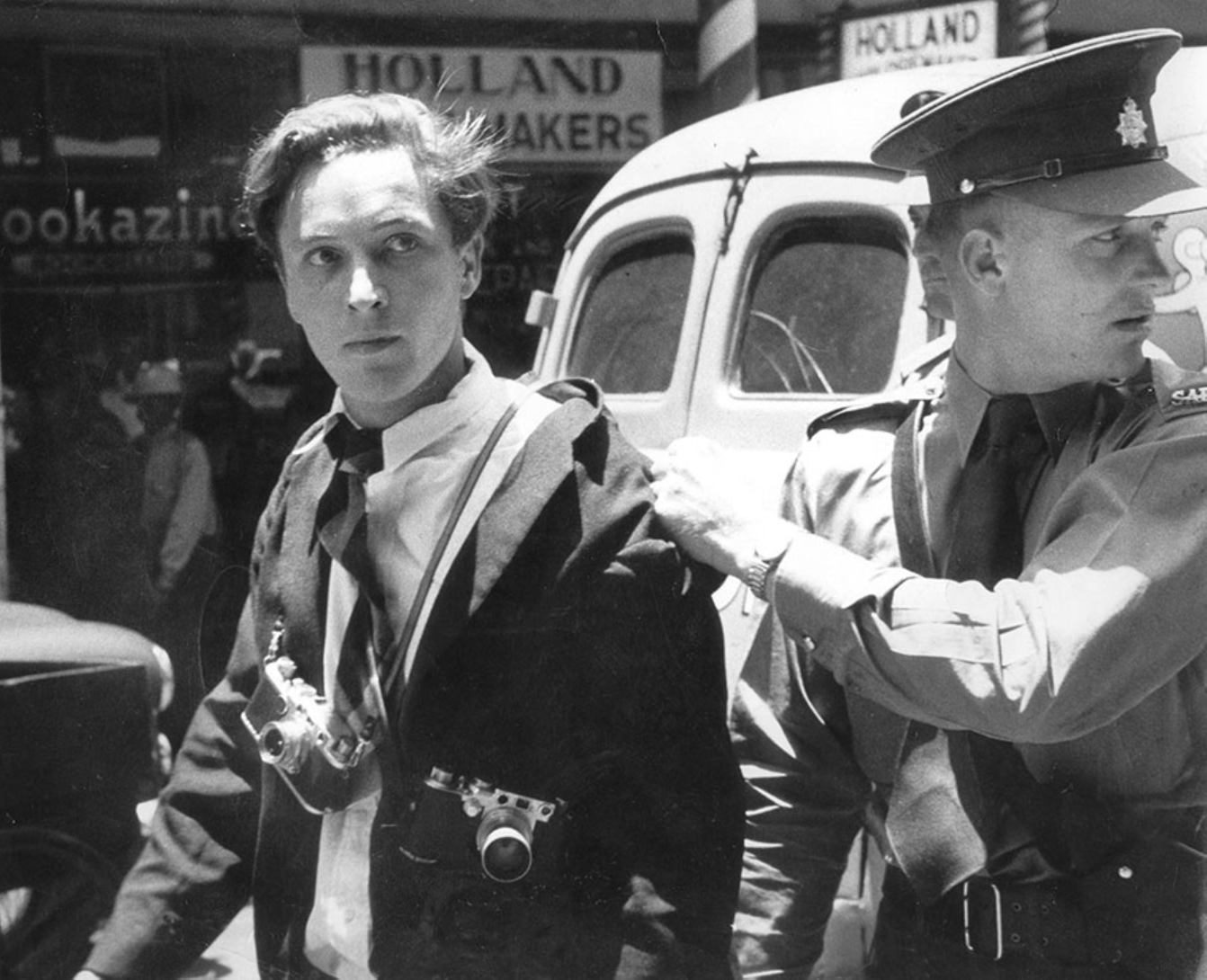Jürgen Schadeberg being arrested in Johannesburg for protecting one of his colleagues at Drum magazine, 1958. Photograph © Ian Berry.png