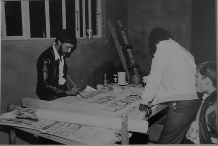 Elvis Govender preparing posters for the Krishna Rabilal Memorial (Motala Massacre, Mozambique), Merebank, 1984
