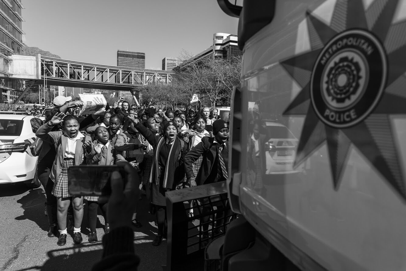 Student protesting in front of the Police Water truck