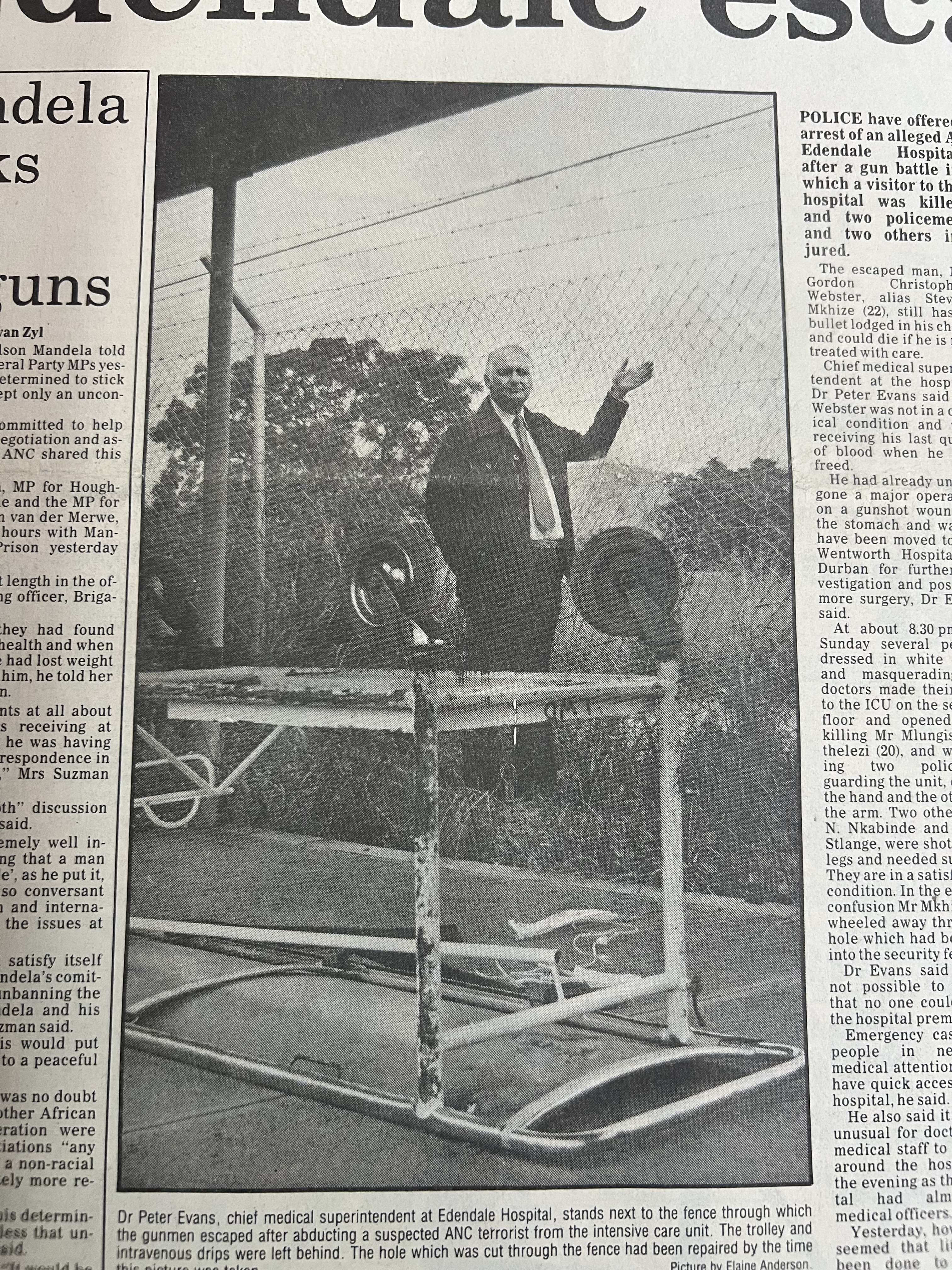 Dr Peter Evans stand next to the fence through which the gunmen escaped, The Natal Witness, May 1986
