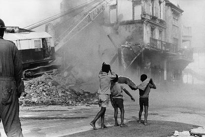 Boys watching destruction of District Six, South Africa, 1974