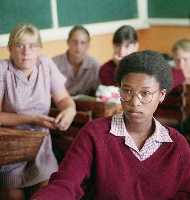 Black pupils arrive at school escorted by police officers