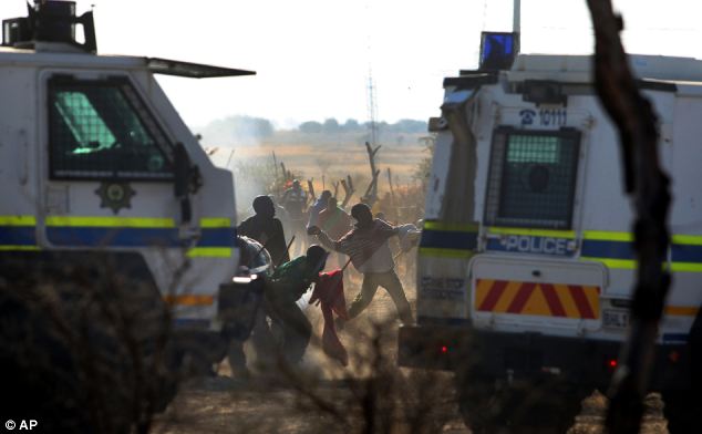 Police open fire, killing 34 striking mine-workers at Marikana