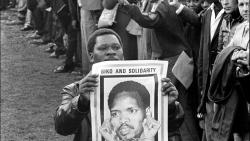 A Black Consciousness Movement member with a poster of Steve Biko