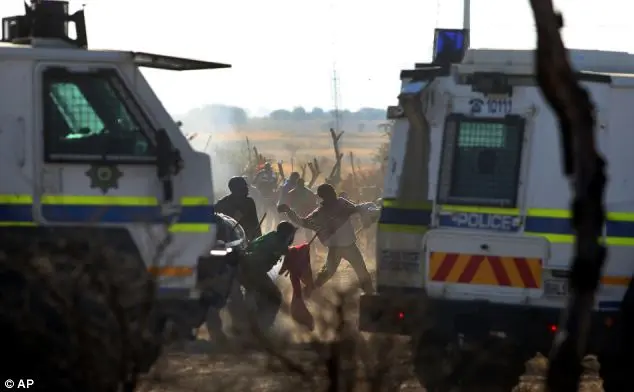 Police open fire, killing 34 striking mine-workers at Marikana