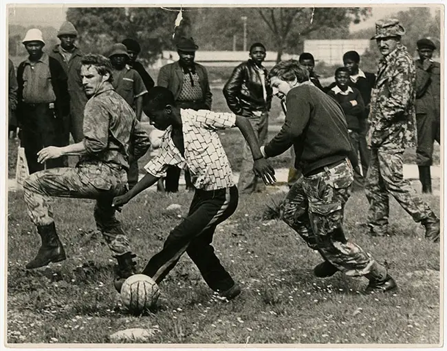 Riot police play a game of soccer with youths in Nyanga on 27 August 1976