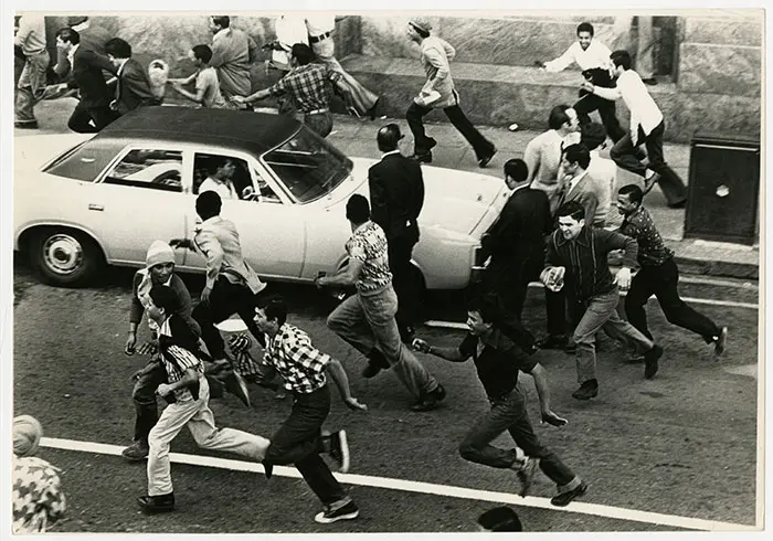 Crowds scatter up Darling Street