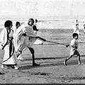 A child guiding Gandhiji
