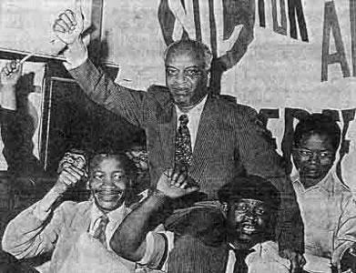 GM Naicker, President of the Natal Indian Congress, held aloft