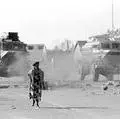 A woman walks to work during clashes in Tokoza May 22, 1993