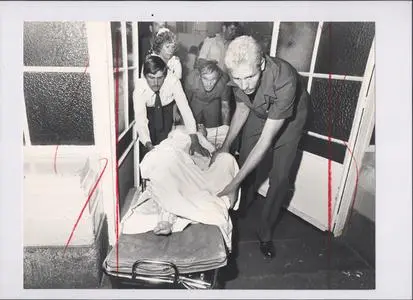 Injured victim wheeled into hospital. Silverton Siege, 1980.