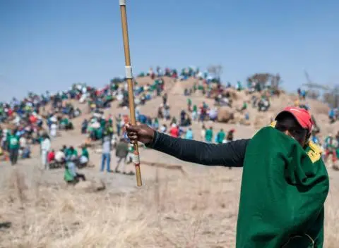 A miner wears a green blanket