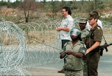 A seconded white South African army officer watches a paramilitary policemen with the Ciskeien homeland security forces