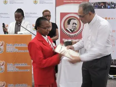 A student receiving her award from the Deputy Minister of Basic Education, Mr Enver Surty.