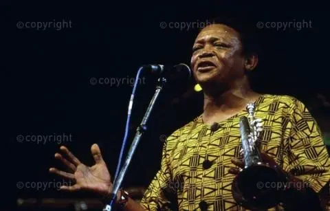 Hugh Masekela in front of microphone