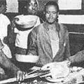 Miners food" shovelled into metal containers "