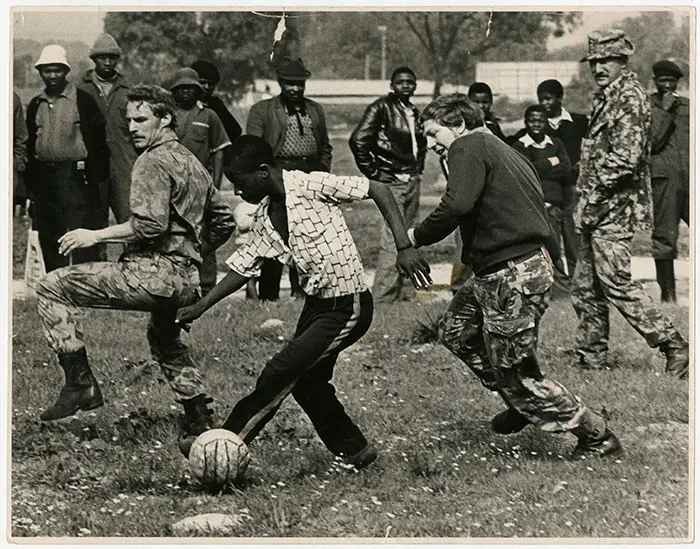 Riot police play a game of soccer with youths in Nyanga on 27 August 1976