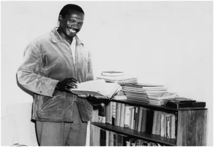 Robert Sobukwe going through a book while detained on Robben Island
