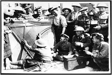 South African Soldiers on the Western Front having dinner to music played from the inside of an old piano