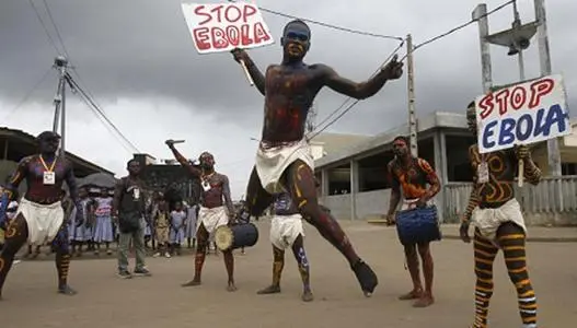 Actors parade on a street during campaign against Ebola