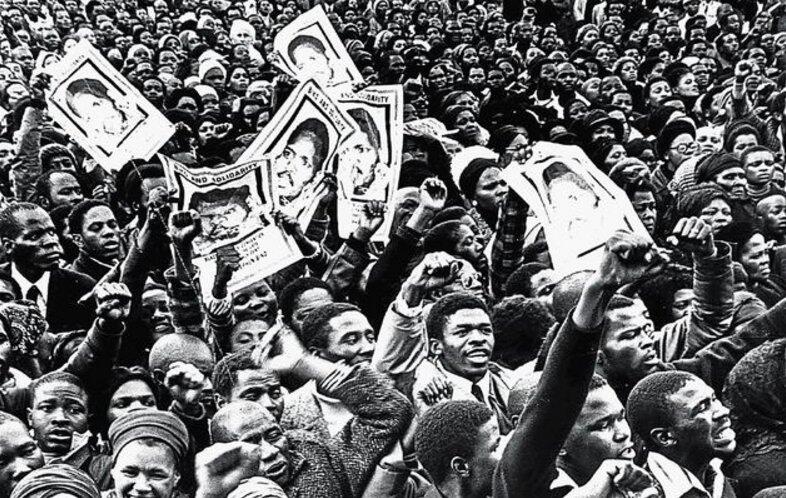 Demonstrators hold up images of Steve Biko at his funeral in September 1977 after he had been murdered in police custody.
