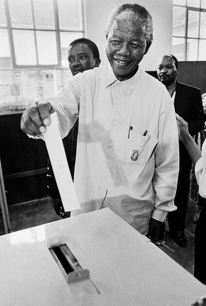 Nelson Mandela casts his vote in the first South African elections held without racial discrimination against voters on this day in 1994