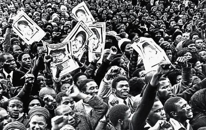 Demonstrators hold up images of Steve Biko at his funeral in September 1977 after he had been murdered in police custody.