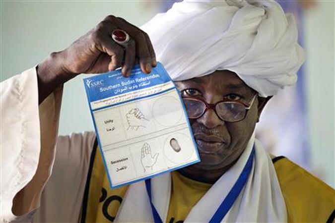 A Southern Sudan Referendum Commission staff member shows the voting ballot during the official counting of votes