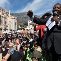 President Cyril Ramaphosa appears before protesters against gender- based violence in South Africa