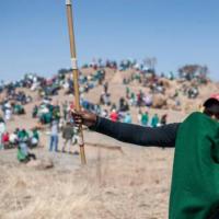 A miner wears a green blanket 