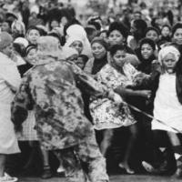 Black demonstrators cower from a police dog at Gugulethu township near Cape Town on 12 August 1976