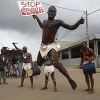 Actors parade on a street during campaign against Ebola